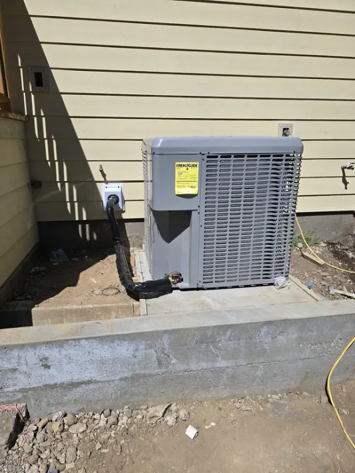 Central air conditioning unit on a concrete equipment pad