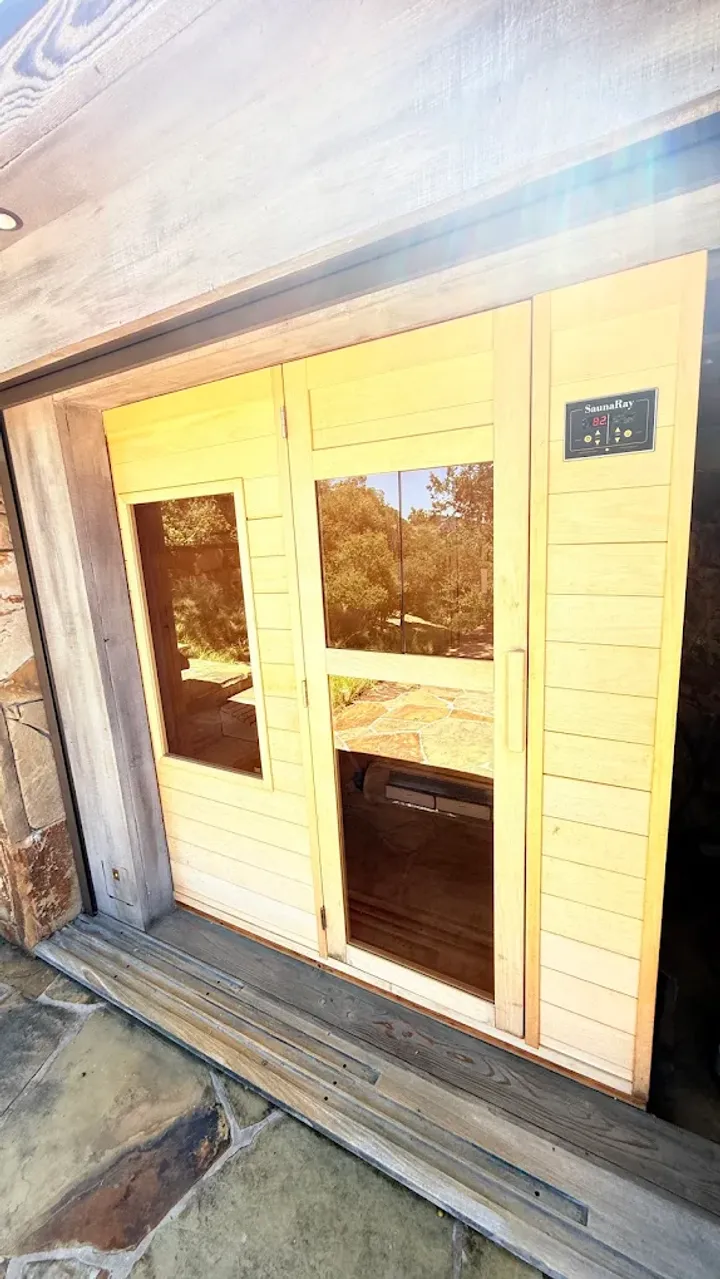 Wood-lined sauna with glass entrance doors