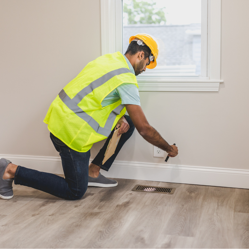 Technician inspecting a wall vent