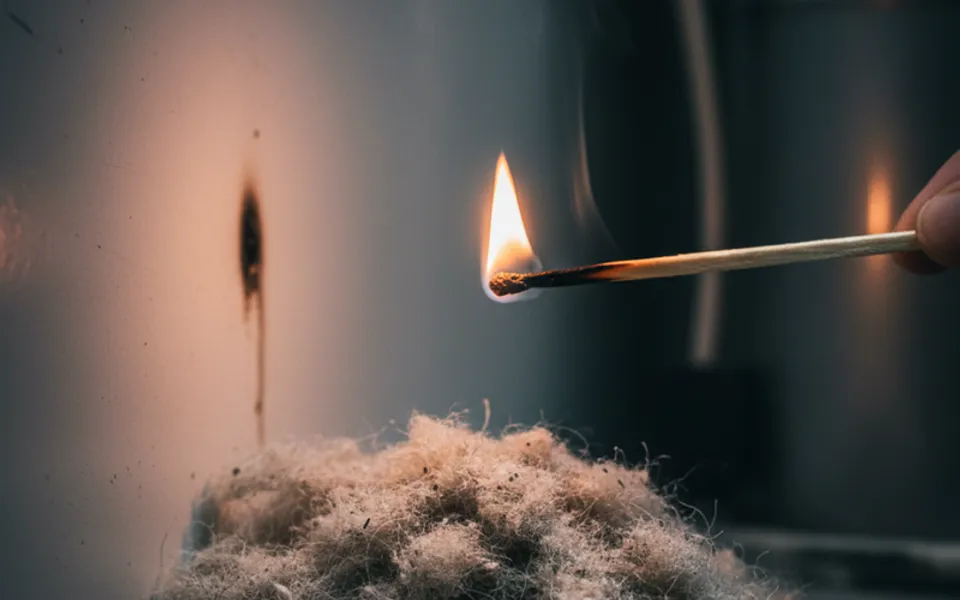 Illustration of a flame near accumulated dryer lint